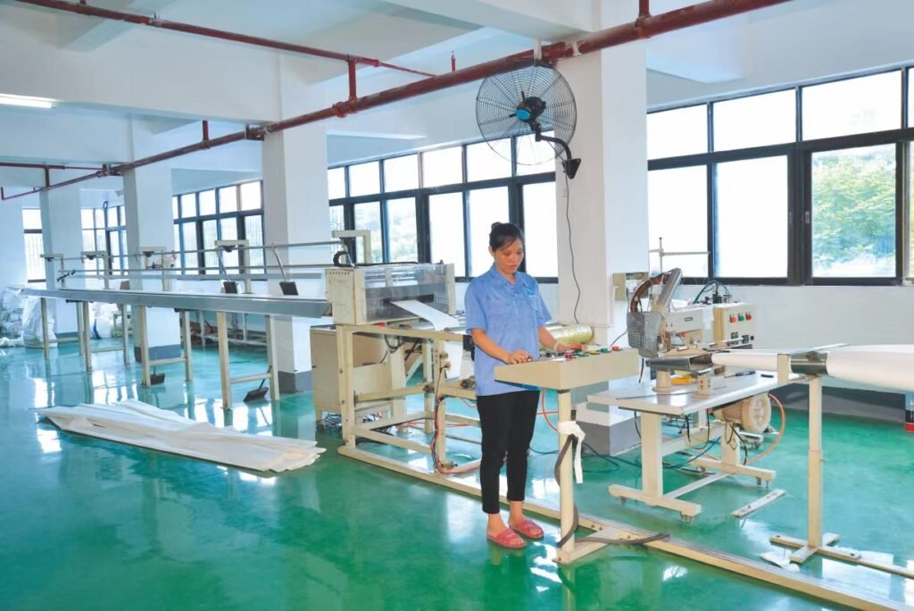 a woman worker is working intently in front of a machine in the workshop